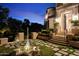 Elegant home entrance with fountain at night at 9848 E Parkside Ln, Scottsdale, AZ 85255
