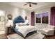 Elegant bedroom with plush velvet headboard, large window, and ensuite bathroom access at 9848 E Parkside Ln, Scottsdale, AZ 85255