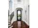 Grand entryway with a curved staircase and large door at 9848 E Parkside Ln, Scottsdale, AZ 85255