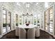 Formal dining room features a round table, chandelier, and bird wallpaper at 9848 E Parkside Ln, Scottsdale, AZ 85255