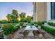 Brick patio with a stone table, benches, and lush landscaping at 9848 E Parkside Ln, Scottsdale, AZ 85255