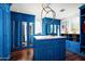 Spacious walk-in closet with blue cabinetry and center island at 9848 E Parkside Ln, Scottsdale, AZ 85255