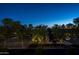 Community area with benches, trees, and a covered patio at night at 9848 E Parkside Ln, Scottsdale, AZ 85255
