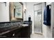Modern bathroom with dark vanity, shower, and mosaic tile accents at 9848 E Parkside Ln, Scottsdale, AZ 85255