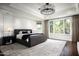 Main bedroom with hardwood floors, large windows, and a cozy fireplace at 9848 E Parkside Ln, Scottsdale, AZ 85255