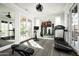 Bright home gym with a mirrored wall, treadmill, and exercise bike at 9848 E Parkside Ln, Scottsdale, AZ 85255