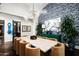 Modern dining room with long table, statement chandelier and green buffet at 9848 E Parkside Ln, Scottsdale, AZ 85255