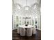 Elegant dining room with a round table, chandelier, and bird wallpaper at 9848 E Parkside Ln, Scottsdale, AZ 85255