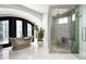 Bathroom with walk-in shower, soaking tub, and natural light at 9848 E Parkside Ln, Scottsdale, AZ 85255