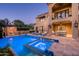 Stunning pool and spa with outdoor seating and lighting at 9848 E Parkside Ln, Scottsdale, AZ 85255