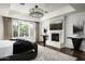 Spacious main bedroom with fireplace, large windows, and hardwood floors at 9848 E Parkside Ln, Scottsdale, AZ 85255