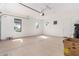 Attached garage with an overhead door and window at 8628 W Solano Dr, Glendale, AZ 85305