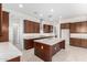 Spacious kitchen with island, stainless steel appliances, and quartz countertops at 8628 W Solano Dr, Glendale, AZ 85305