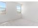 Spacious bedroom with two windows and carpet flooring at 8628 W Solano Dr, Glendale, AZ 85305