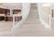 Modern staircase with white railing and carpet at 8628 W Solano Dr, Glendale, AZ 85305