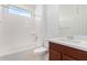 Clean bathroom with tub, toilet, and modern vanity at 8628 W Solano Dr, Glendale, AZ 85305