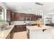 Spacious kitchen with island, granite countertops, and dark wood cabinets at 3702 W Riordan Ranch Rd, Phoenix, AZ 85083