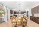 Kitchen boasts dark wood cabinets, an island, and a large dining table at 3702 W Riordan Ranch Rd, Phoenix, AZ 85083