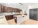 Modern kitchen with dark cabinetry, an island, and stainless steel appliances at 3702 W Riordan Ranch Rd, Phoenix, AZ 85083