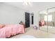 Bright bedroom with twin bed, mirrored closet doors, and access to other rooms at 3702 W Riordan Ranch Rd, Phoenix, AZ 85083