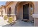 Front entrance with arched entryway and a decorative doormat at 3702 W Riordan Ranch Rd, Phoenix, AZ 85083