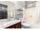 Clean bathroom with a shower/tub combo, updated vanity, and shelves at 3702 W Riordan Ranch Rd, Phoenix, AZ 85083
