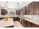 Modern kitchen with granite countertops, stainless steel appliances, and an abundance of cabinetry at 3702 W Riordan Ranch Rd, Phoenix, AZ 85083