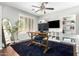 Home office with built-in shelving, a large desk, and plenty of natural light at 3702 W Riordan Ranch Rd, Phoenix, AZ 85083