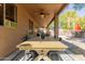 Covered patio with dining table, seating area, and ceiling fan at 3702 W Riordan Ranch Rd, Phoenix, AZ 85083