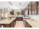 Open kitchen with large island, granite countertops, and stainless steel appliances at 3702 W Riordan Ranch Rd, Phoenix, AZ 85083