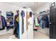 Bright walk-in closet with custom shelving and hanging rods at 3702 W Riordan Ranch Rd, Phoenix, AZ 85083