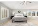 Bright bedroom with a large bed and plantation shutters at 3702 W Riordan Ranch Rd, Phoenix, AZ 85083