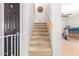 Carpeted staircase with a wooden handrail and a baby gate at 3702 W Riordan Ranch Rd, Phoenix, AZ 85083