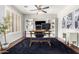 Bright home office features built-in shelving, large desk, and hardwood floors at 3702 W Riordan Ranch Rd, Phoenix, AZ 85083
