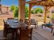 Outdoor dining area on patio with large wooden table and chairs at 12909 W Meeker Blvd, Sun City West, AZ 85375