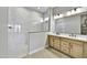 Bathroom with double vanity, frameless shower, and marble tile at 19366 W San Juan Ave, Litchfield Park, AZ 85340