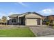 Single-story home with a two-car garage and landscaped front yard at 19366 W San Juan Ave, Litchfield Park, AZ 85340