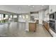 Open concept kitchen with island, stainless steel appliances, and tile floors at 19366 W San Juan Ave, Litchfield Park, AZ 85340