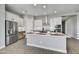 Modern kitchen with an island, stainless steel appliances, and white cabinets at 19366 W San Juan Ave, Litchfield Park, AZ 85340