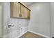 Laundry room with wood cabinets and hookups for washer/dryer at 19366 W San Juan Ave, Litchfield Park, AZ 85340