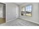 Bright home office features carpet, neutral walls, and large windows at 19366 W San Juan Ave, Litchfield Park, AZ 85340