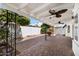 Covered patio with brick flooring, ceiling fan, and surrounding greenery at 7632 E Bonita Dr, Scottsdale, AZ 85250