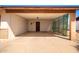 Covered carport with concrete flooring and a side gate at 526 E Viola St, Casa Grande, AZ 85122