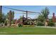 This is a photo of a playground with covered play areas, swings, and climbing equipment at 19366 W San Juan Ave, Litchfield Park, AZ 85340