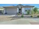 House exterior showcasing a two-car garage and well-maintained landscaping at 1957 W Fawn Way, San Tan Valley, AZ 85144