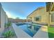 Refreshing pool with artificial turf and landscaping at 1957 W Fawn Way, San Tan Valley, AZ 85144