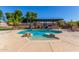 Inviting kidney-shaped pool with a pergola and outdoor kitchen at 10913 N 153Rd Ln, Surprise, AZ 85379