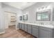 Elegant bathroom with double vanity, large mirror, and walk-in closet at 10913 N 153Rd Ln, Surprise, AZ 85379