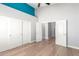 Well-lit bedroom with double door closet and wood flooring at 10913 N 153Rd Ln, Surprise, AZ 85379