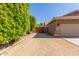 Private driveway with wood gate and mature shrubs at 10913 N 153Rd Ln, Surprise, AZ 85379